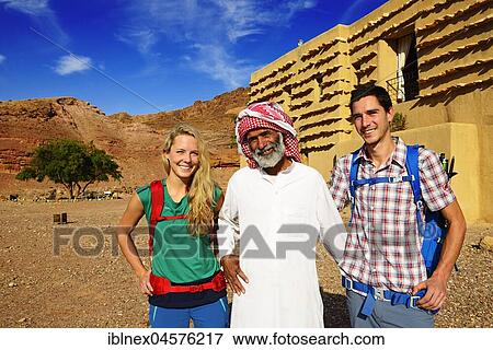 Stock Photo - Bedouin with Tourists in front of Feynan Ecolodge, Jordan, Asia. Fotosearch