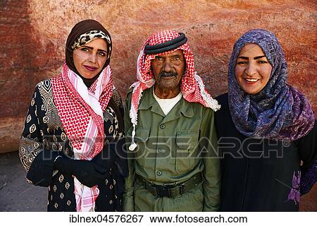 Stock Photo - Bedouins pose at colourful rock-formations in Petra, Wadi Musa, Jordan, Asia. Fotosearch