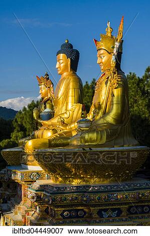 Big golden statues of Padmasambhava, Shakyamuni Buddha and Maitreya Buddha at back of Swayambhunath temple, snow covered mountains behind, Kathmandu, Nepal, Asia View Large Photo Image Stock Photo - Big golden statues of Padmasambhava, Shakyamuni Buddha and Maitreya Buddha at back of Swayambhunath temple, snow covered mountains behind, Kathmandu, Nepal, Asia. Fotosearch