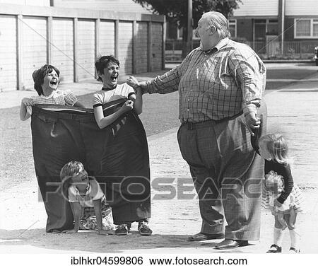 Big man with children, England, Great Britain View Large Photo Image Stock Photograph - Big man with children, England, Great Britain. Fotosearch