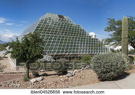 Stock Photograph - Biosphere 2, self-sustaining ecosystem, cactus in front of facility with tropical rainforest, Oracle, Arizona, USA, North America. Fotosearch
