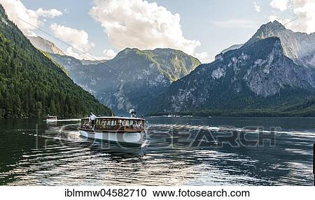 Stock Image - Boat with tourists on the Königssee, Schönau am Königssee, National Park Berchtesgaden area, Berchtesgaden, Upper Bavaria, Bavaria, Germany, Europe. Fotosearch