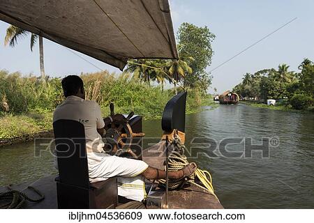 Boatman on kettuvallam, houseboat, Backwaters near Alappuzha, Malabar Coast, Kerala, India, Asia View Large Photo Image Stock Photo - Boatman on kettuvallam, houseboat, Backwaters near Alappuzha, Malabar Coast, Kerala, India, Asia. Fotosearch