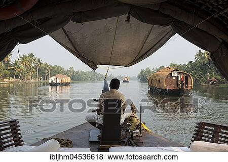 Stock Photo - Boatman on kettuvallam, houseboat, Backwaters near Alappuzha, Malabar Coast, Kerala, India, Asia. Fotosearch
