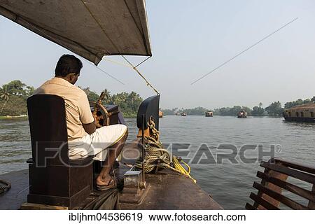 Stock Photo - Boatman on kettuvallam, houseboat, Backwaters near Alappuzha, Malabar Coast, Kerala, India, Asia. Fotosearch