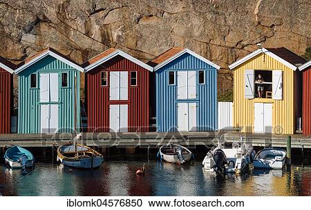 Stock Image - Boats and colourful boathouses in the harbour of Smögen, Smögenbryggan, Västra Götalands Län, Bohuslän, Sweden, Europe. Fotosearch
