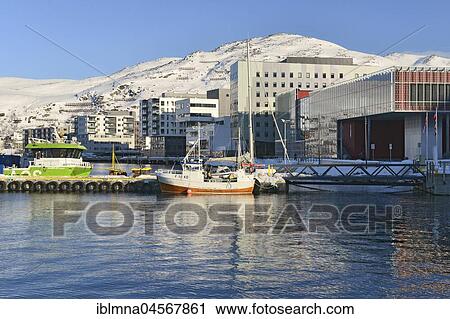 Stock Image - Boats and residential buildings on the shore of a bay, Hammerfest, Finnmark, Norway, Europe. Fotosearch