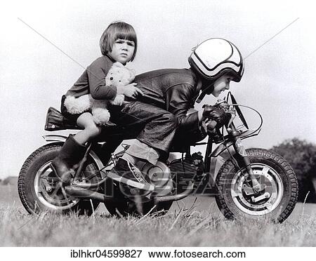 Boy and girl riding a motorcycle, England, Great Britain View Large Photo Image Stock Photo - Boy and girl riding a motorcycle, England, Great Britain. Fotosearch