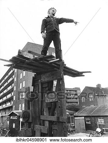 Stock Image - Boy on climbing object made of wood, England, Great Britain. Fotosearch