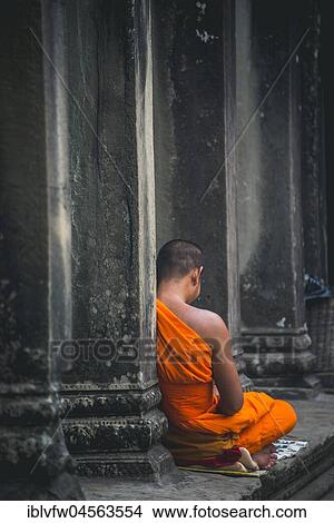 Buddhist monk meditates in colonnade, temple complex of Angkor Wat, Angkor Archaeological Park, province of Siem Reap, Cambodia, Asia View Large Photo Image Picture - Buddhist monk meditates in colonnade, temple complex of Angkor Wat, Angkor Archaeological Park, province of Siem Reap, Cambodia, Asia. Fotosearch