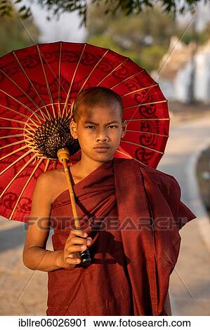 Buddhist monk stands with red umbrella on a path, Mingun, Myanmar, Asia View Large Photo Image Stock Image - Buddhist monk stands with red umbrella on a path, Mingun, Myanmar, Asia. Fotosearch