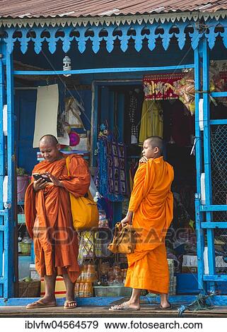 Stock Photo - Buddhist Monks on Houseboat, Floating Village, Boat Trip, Tonle Sap Lake, Cambodia, Southeast Asian Islands, Asia. Fotosearch