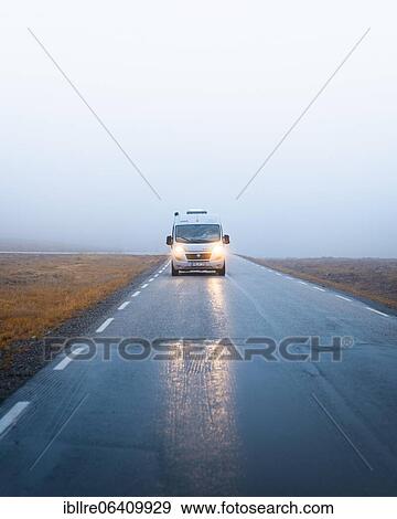 Stock Photo - Campervan with bright lights on a road near the North Cape, North Cape, Norway, Europe. Fotosearch