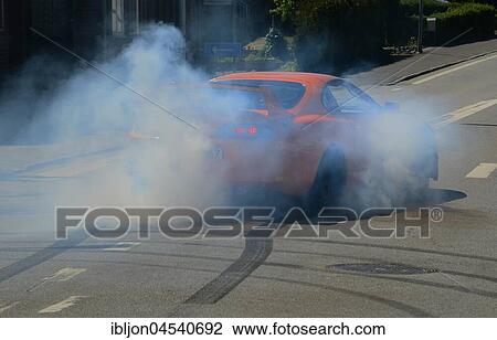 Stock Image - Car burning tire on a street, Rydsgård, Scania, Sweden, Europe. Fotosearch