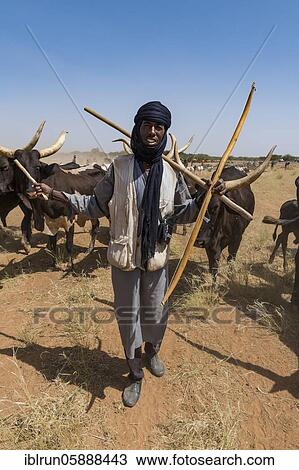 Caravan of Peul nomads with their animals in the Sahel of Niger View Large Photo Image Stock Image - Caravan of Peul nomads with their animals in the Sahel of Niger. Fotosearch