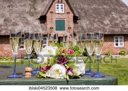 Champagne glasses and bouquet in front of Öörang Hüs, museum, Amrum, North Frisian Islands, Schleswig-Holstein, Germany, Europe View Large Photo Image Stock Photo - Champagne glasses and bouquet in front of Öörang Hüs, museum, Amrum, North Frisian Islands, Schleswig-Holstein, Germany, Europe. Fotosearch