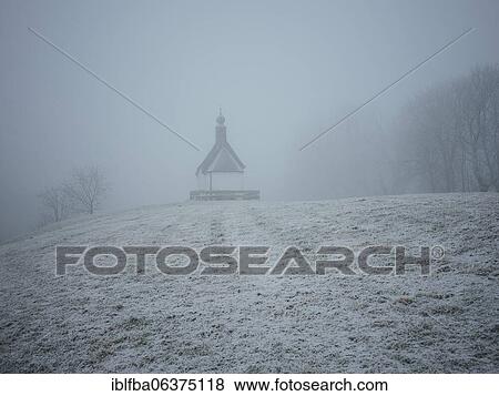 Stock Photo - Chapel, first snow, fog, Stadlbergalm, Miesbach, Upper Bavaria, Bavaria, Germany, Europe. Fotosearch