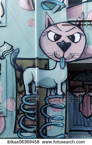 Stock Photo - Cheeky cat on coil springs shows tongue, graffito in comic style, Düsseldorf, North Rhine-Westphalia, Germany, Europe. Fotosearch