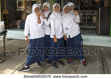 Stock Image - Cheerful Muslim schoolgirls in school uniforms posing for camera, Yogyakarta, Java, Indonesia, Asia. Fotosearch