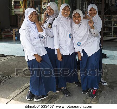 Stock Photo - Cheerful Muslim schoolgirls in school uniforms posing for camera, Yogyakarta, Java, Indonesia, Asia. Fotosearch