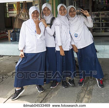 Stock Photo - Cheerful Muslim schoolgirls in school uniforms posing for camera, Yogyakarta, Java, Indonesia, Asia. Fotosearch