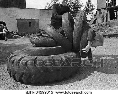 Child playing with tyres, England, Great Britain View Large Photo Image Stock Photography - Child playing with tyres, England, Great Britain. Fotosearch