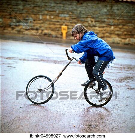 Child rides a bicycle from two parts, England, Great Britain View Large Photo Image Stock Photo - Child rides a bicycle from two parts, England, Great Britain. Fotosearch