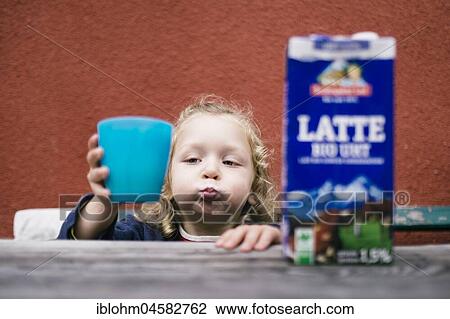 Stock Image - Child with cup, milk, Germany, Europe. Fotosearch
