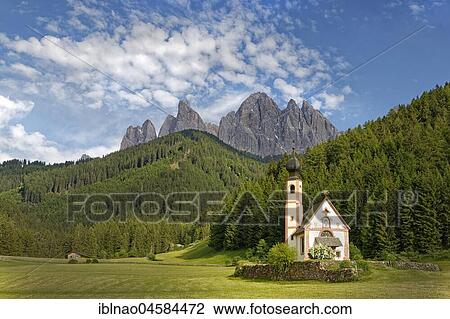 Stock Image - Church St. Johann in Ranui with Odle Group mountain range, Villnöß valley, Alto Adige, Italy, Europe. Fotosearch