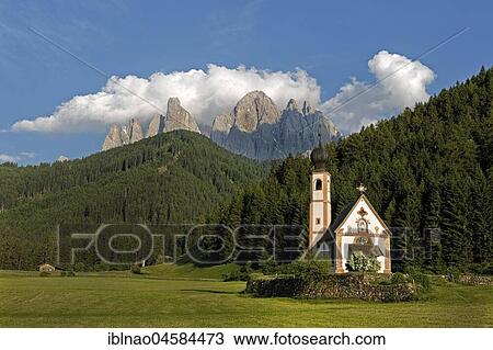 Stock Image - Church St. Johann in Ranui with Odle Group mountain range, Villnöß valley, Alto Adige, Italy, Europe. Fotosearch