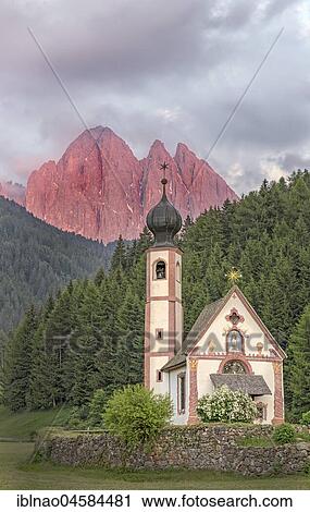 Stock Image - Church St. Johann in Ranui with Odle Group mountain range, Villnöß valley, Alto Adige, Italy, Europe. Fotosearch