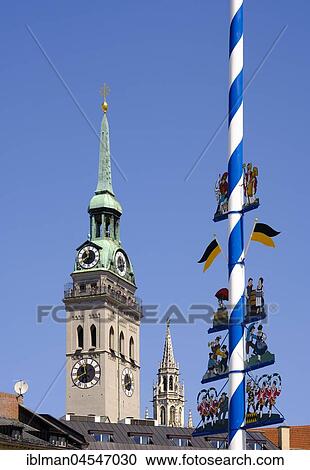Stock Image - Church tower Alter Peter, church of St. Peter, town hall and Maypole at Viktualienmarkt, old town, Munich, Upper Bavaria, Bavaria, Germany, Europe. Fotosearch