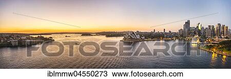 Stock Image - Circular Quay and The Rocks at dusk, skyline with Sydney Opera House, Opera, Financial District, Banking district, Sydney, New South Wales, Australia, Oceania. Fotosearch