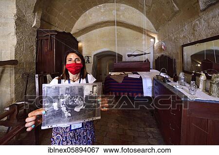 City guide shows old photographs at the Casa Grotta Museum, Matera, Basilicata, Italy, Europe View Large Photo Image Stock Photo - City guide shows old photographs at the Casa Grotta Museum, Matera, Basilicata, Italy, Europe. Fotosearch