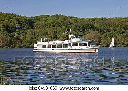 City of Essen excursion boat, Lake Baldeney with ford scaffold of Carl Funke colliery, Essen, Ruhr Area, North Rhine-Westphalia, Germany, Europe View Large Photo Image Stock Photo - City of Essen excursion boat, Lake Baldeney with ford scaffold of Carl Funke colliery, Essen, Ruhr Area, North Rhine-Westphalia, Germany, Europe. Fotosearch
