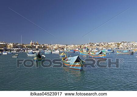 Cityscape with colorful fishing boats, Luzzus, Marsaxlokk, Malta, Europe View Large Photo Image Stock Photo - Cityscape with colorful fishing boats, Luzzus, Marsaxlokk, Malta, Europe. Fotosearch