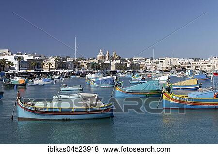Stock Photo - Cityscape with colorful fishing boats, Luzzus, Marsaxlokk, Malta, Europe. Fotosearch