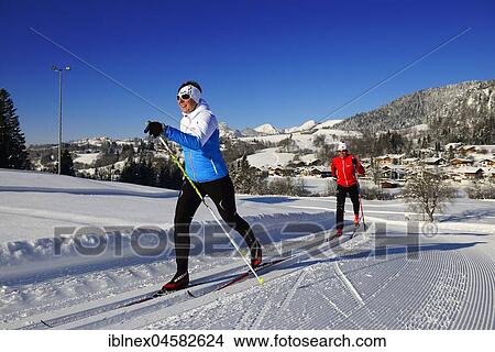 Picture - Classic cross-country skiers on the cross-country ski run, cross-country stadium, Reit im Winkl, Chiemgau, Upper Bavaria, Bavaria, Germany, Europe. Fotosearch