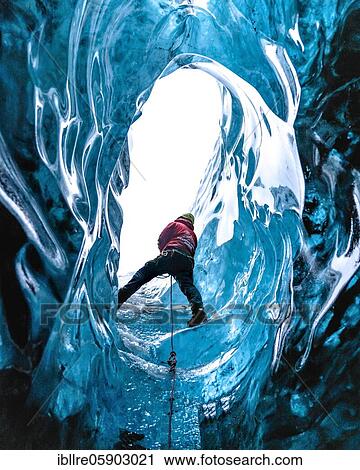 Stock Image - Climber in an ice cave, Vatnajökull glacier, Iceland, Europe. Fotosearch