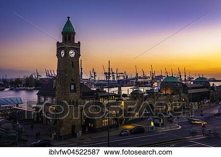 Stock Photo - Clock Tower, Gauging tower, St. Pauli landing stages with harbor at sunset, evening red, landing stages, Elbe, St. Pauli, Hamburg, Germany, Europe. Fotosearch