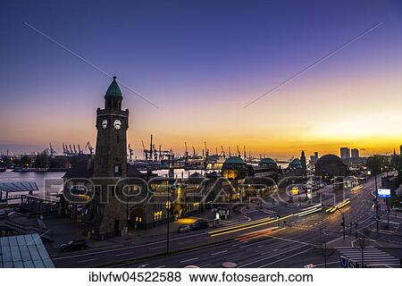 Stock Photo - Clock Tower, Gauging tower, St. Pauli landing stages with harbor at sunset, evening red, landing stages, Elbe, St. Pauli, Hamburg, Germany, Europe. Fotosearch
