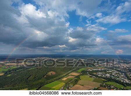 Stock Photograph - Cloud sky with rainbow over Neheim-Hüsten, Arnsberg, Sauerland, North Rhine-Westphalia, Germany, Europe. Fotosearch