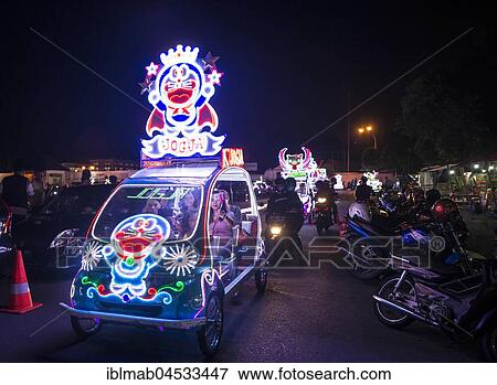 Stock Photo - Colorful with LEDs illuminated cars, pedal car, Yogyakarta, Java, Indonesia, Asia. Fotosearch