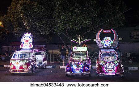Stock Photo - Colorful with LEDs illuminated cars, pedal car, Yogyakarta, Java, Indonesia, Asia. Fotosearch