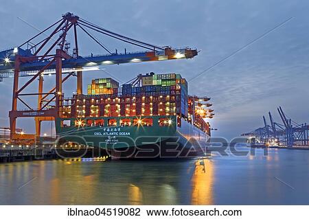 Stock Image - Container ship at night in the port of Hamburg, container terminal Eurogate, Hamburg, Germany, Europe. Fotosearch