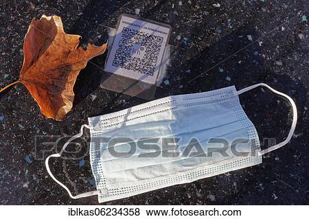 Stock Photo - Corona Restaurant Lockdown, face mask is on a table with QR code, outdoor gastronomy, Düsseldorf, North Rhine-Westphalia, Germany, Europe. Fotosearch
