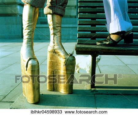 Stock Image - Couple in 70s outfit, platform shoes, England, Great Britain. Fotosearch