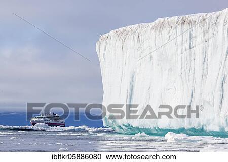 Cruise ship behind iceberg, East coast of Greenland, Denmark, Europe View Large Photo Image Stock Image - Cruise ship behind iceberg, East coast of Greenland, Denmark, Europe. Fotosearch