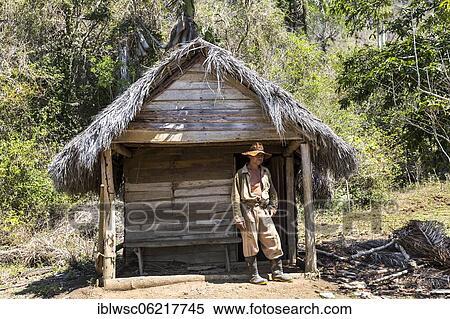 Stock Photography - Cuban farmer in front of his hut, Viñales valley, Cuba, Central America. Fotosearch