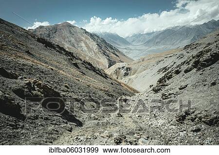 Stock Photo - Daliz Pass, barren rocky landscape, in the background the plain of Sarad-e-Broghil and the western part of the corridor, left the Hindu Kush, right the mountains of the Pamir, Wakhan Corridor, Badakhshan, Afghanistan, Asia. Fotosearch